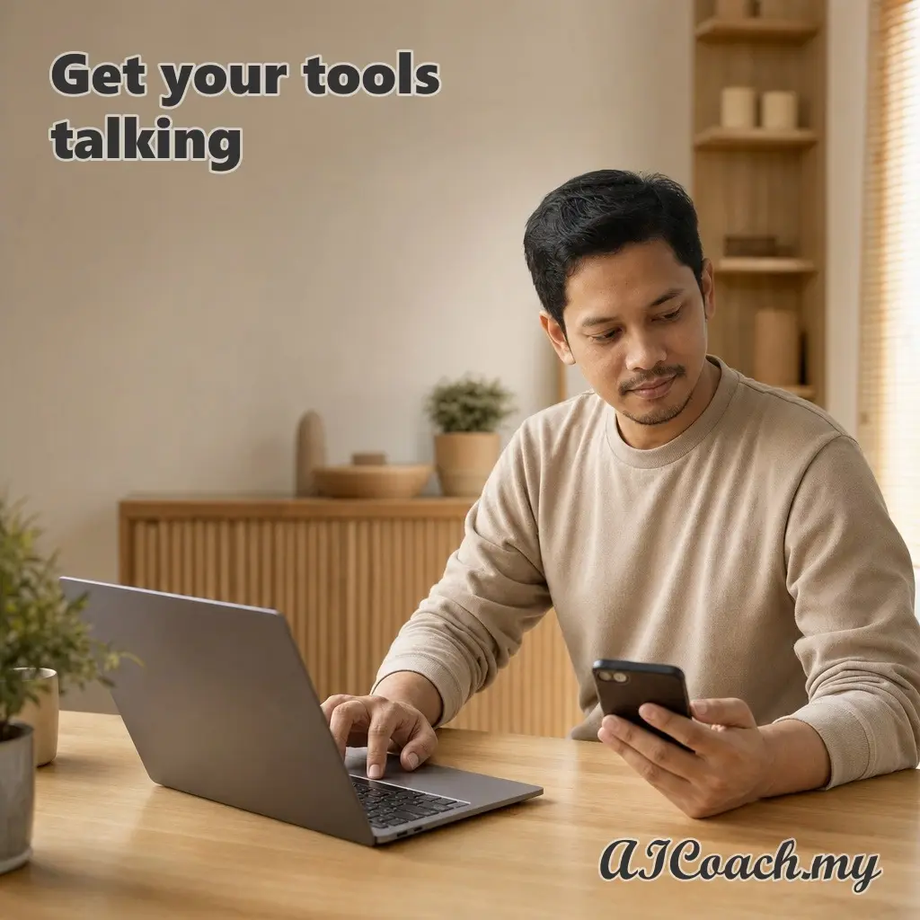 AICoach.my graphic reading 'Get your tools talking', showing a man at a laptop holding a phone in his other hand