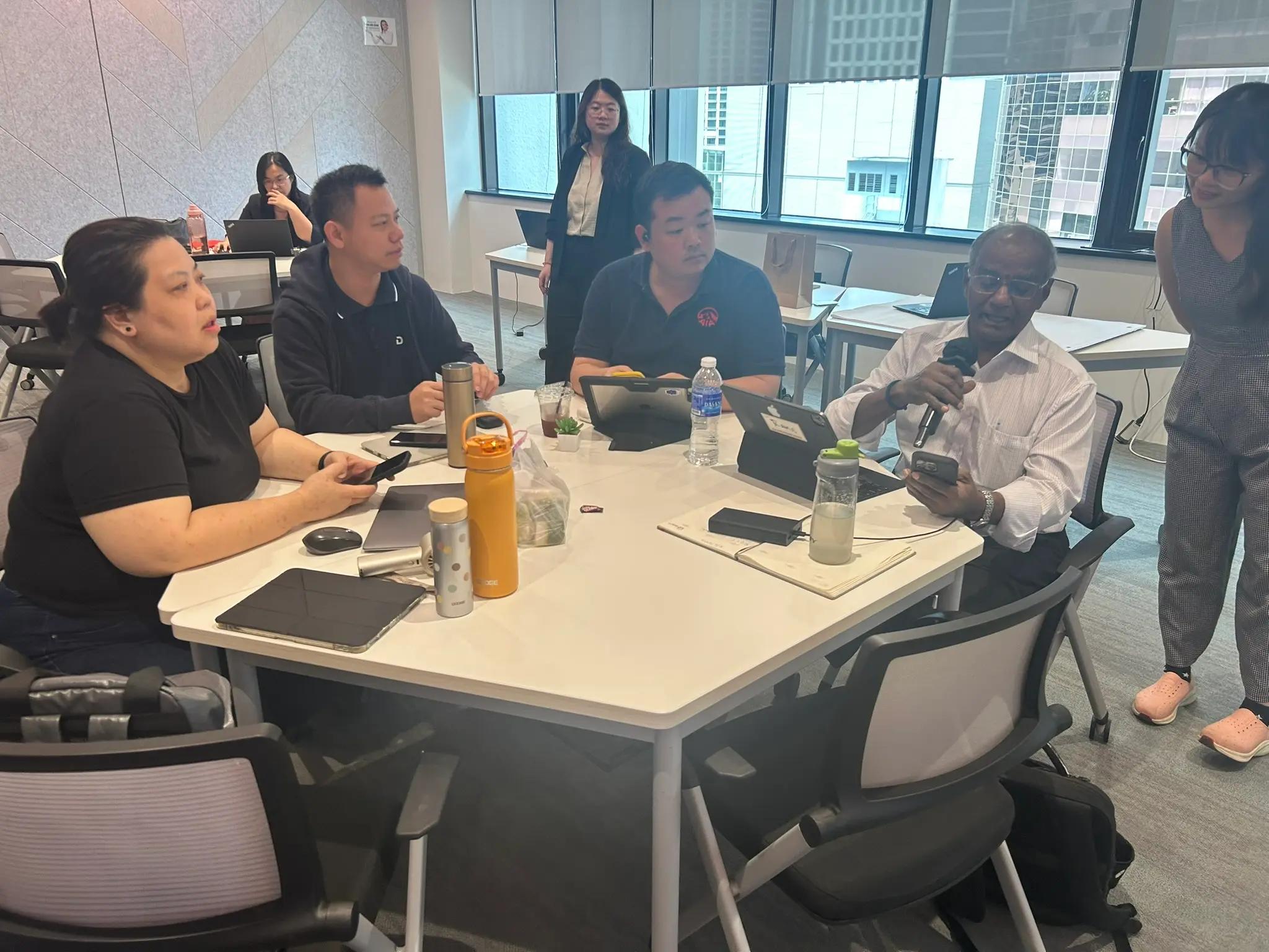 AIA advisors at a table with the Kuala Lumpur skyline in the window behind them, 5 June 2026