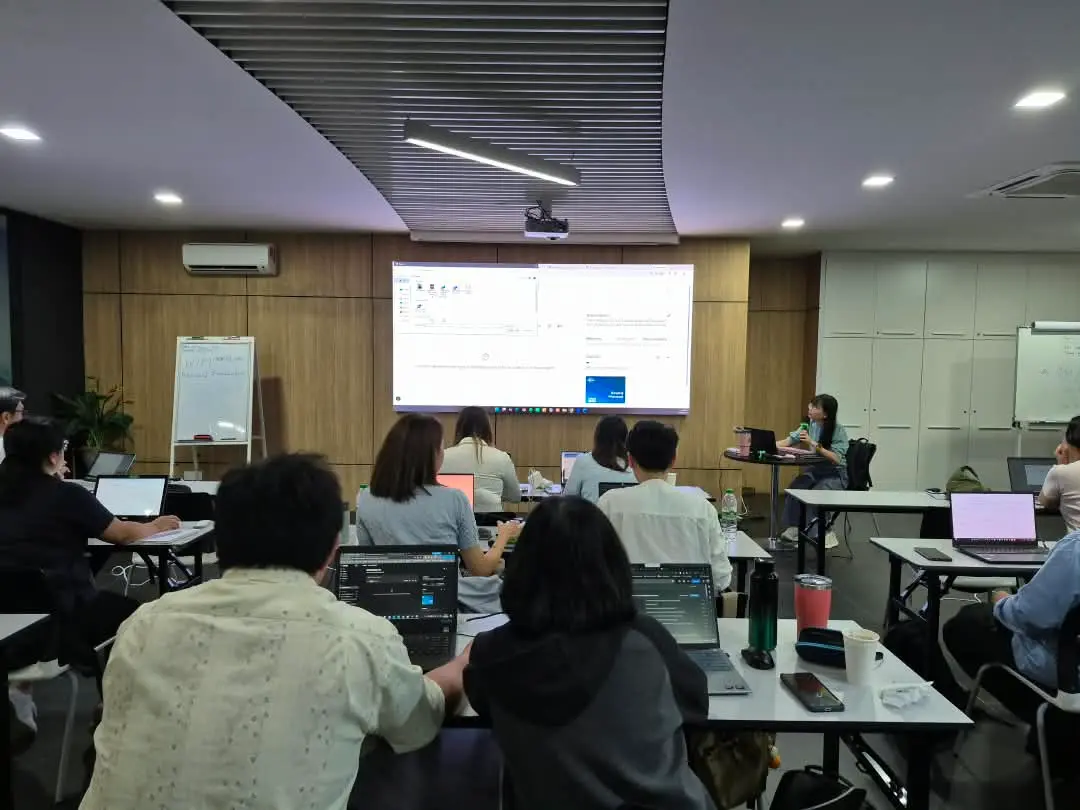 Participants seen from the back of the room following a live demonstration on the big screen, with the trainer seated at the front, Kota Kinabalu, 30 September 2026