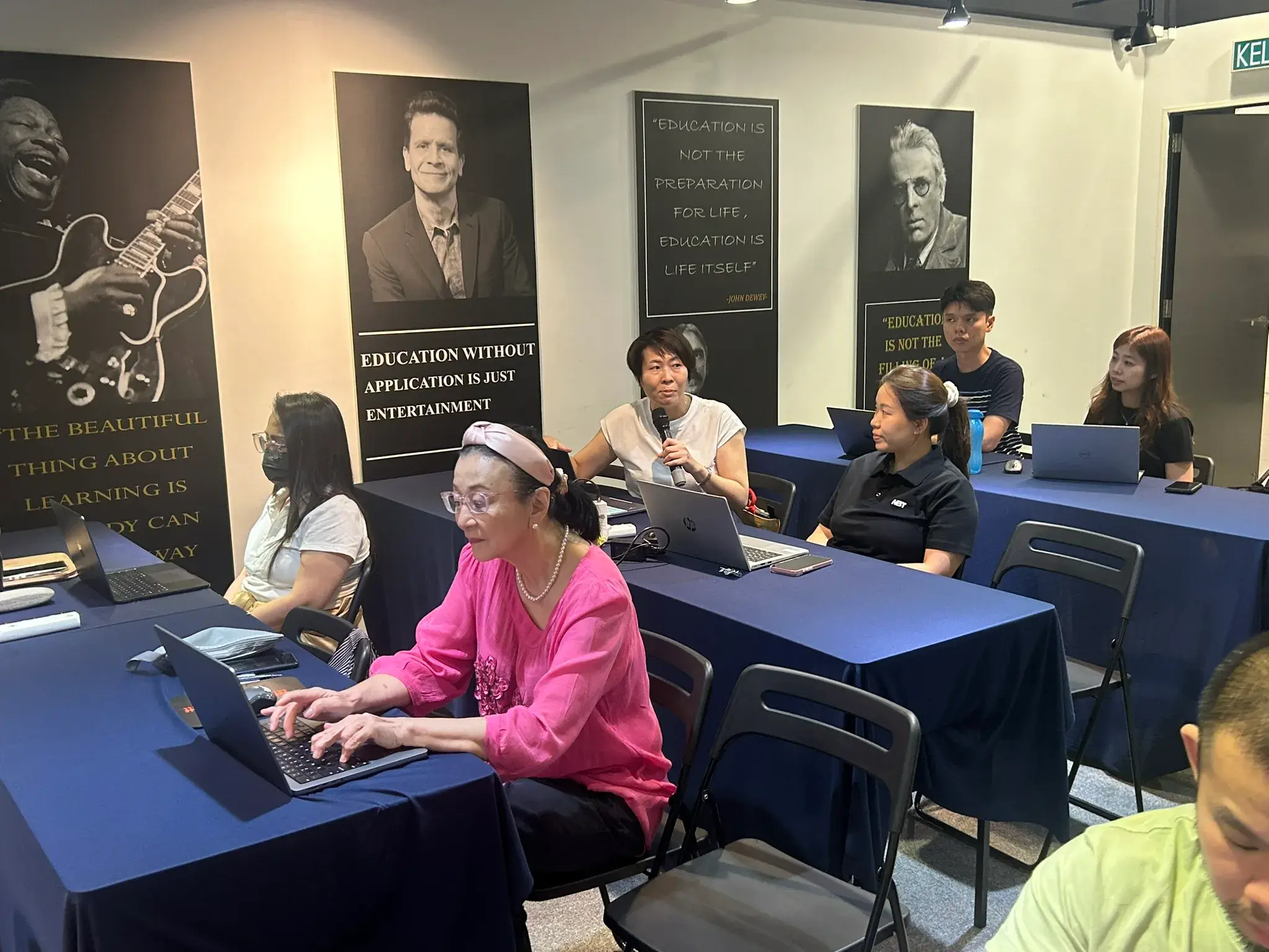 Participants working on AI projects with laptops at Inno Day #3