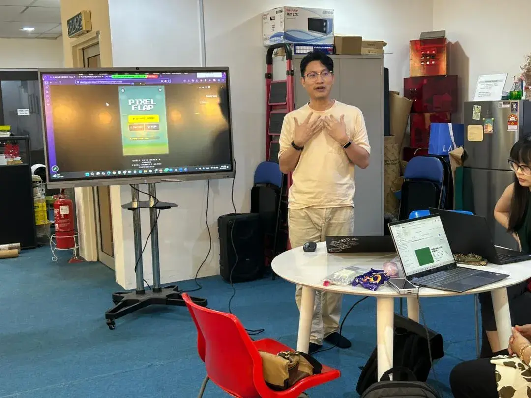 Speaker presenting the Pixel Flap game built with AI at Inno Day #4