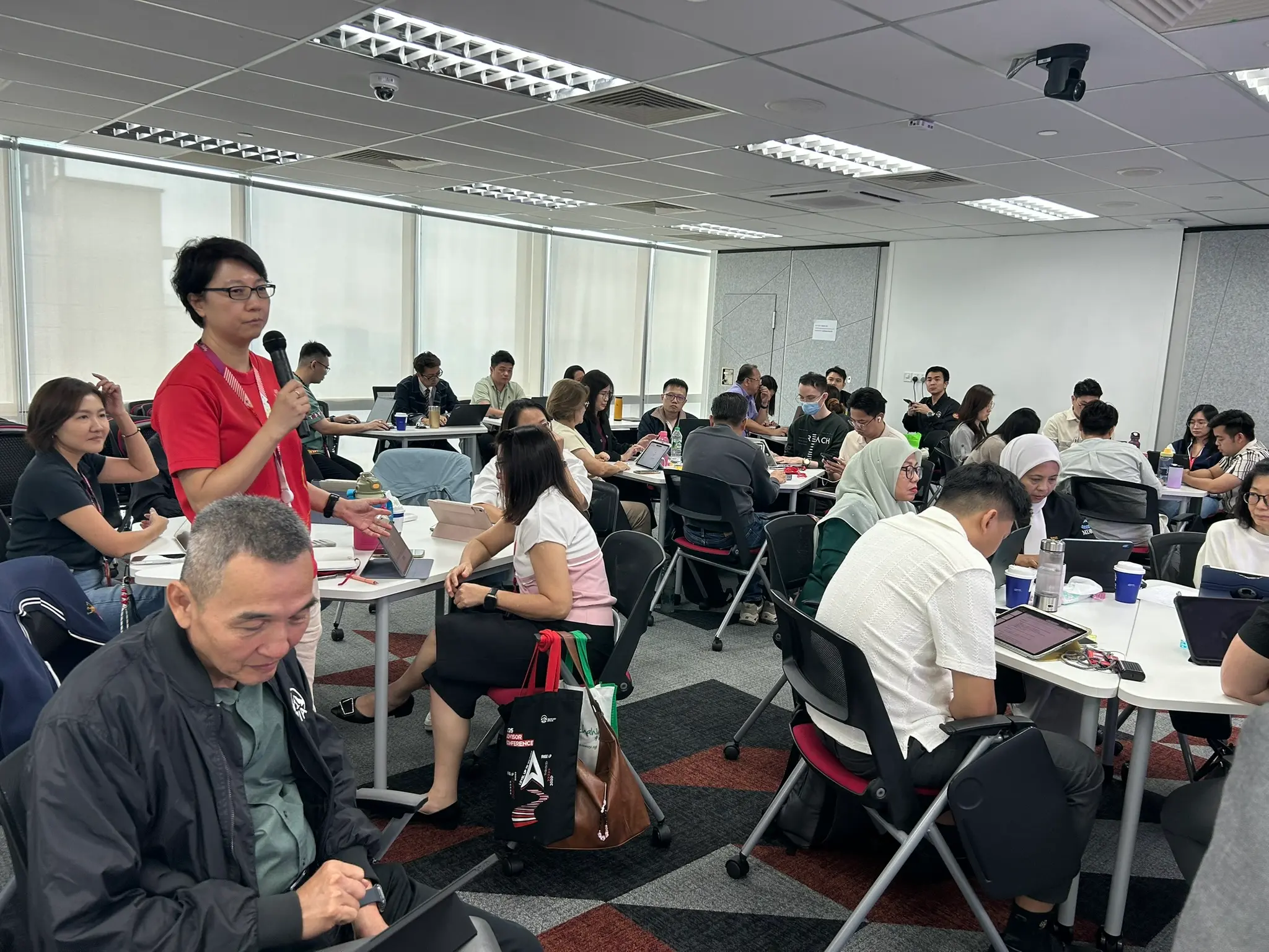 Another advisor standing with the microphone in the middle of the room