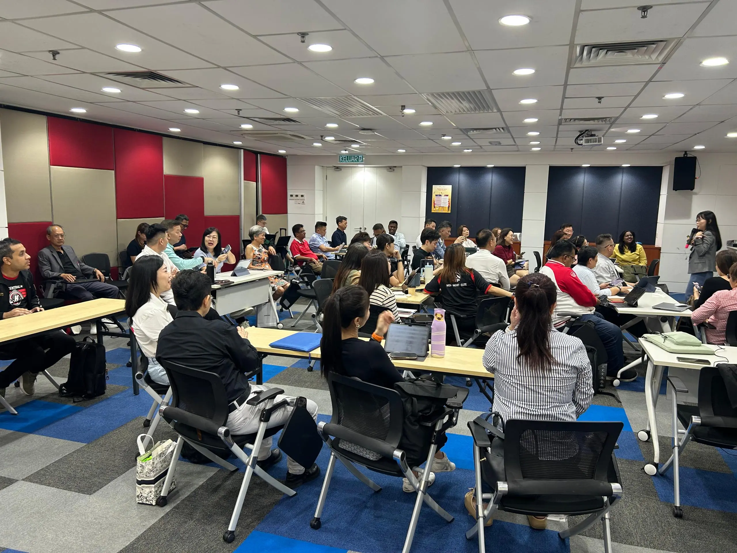 The trainer presenting the day's agenda to a full room in Klang