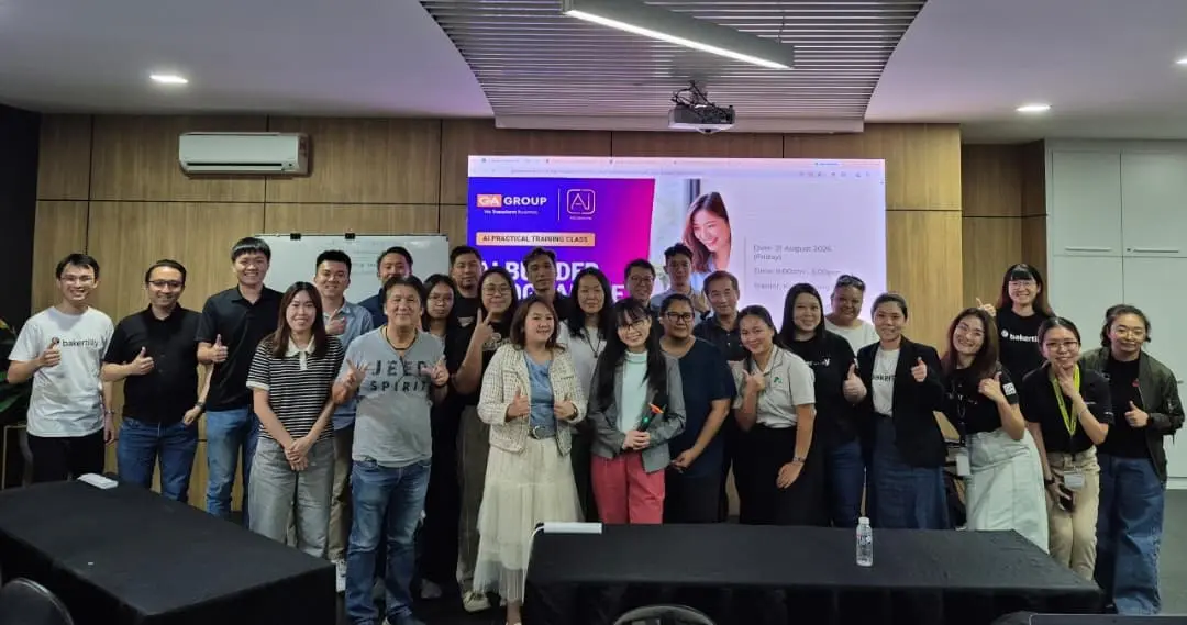 Group photo of around twenty-five participants and trainers with thumbs up at the end of the AI Builder Programme in Kota Kinabalu, 21 August 2026