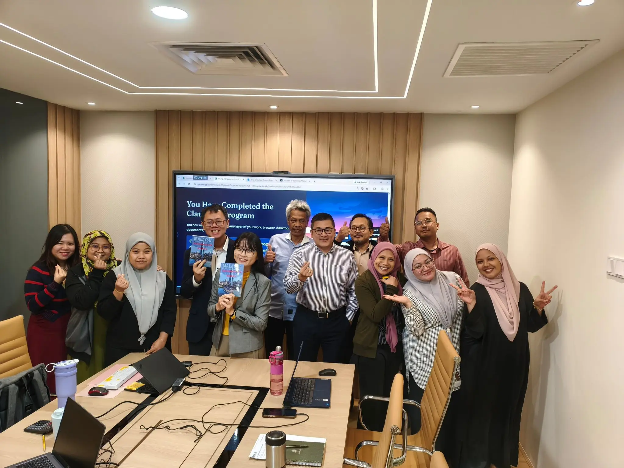 Group photo of the second batch of participants posing in the boardroom at the end of the Claude AI workshop