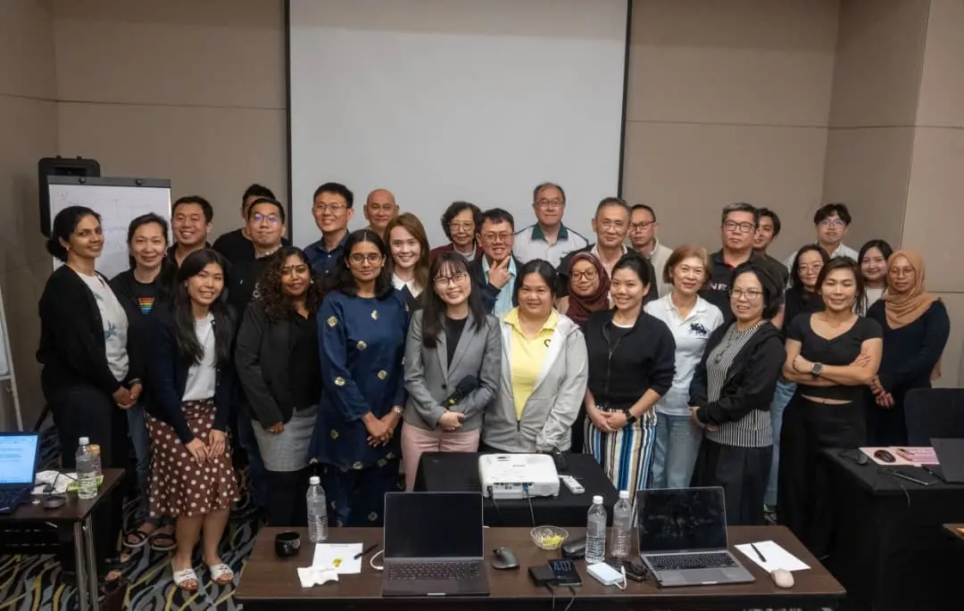 Participants and trainers standing together for a group photo in front of the projector screen, Armada Hotel, Petaling Jaya, September 2026