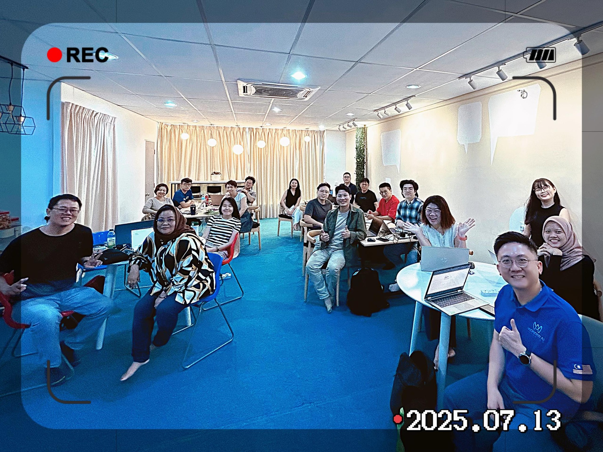 Participants gathered in training room with laptops