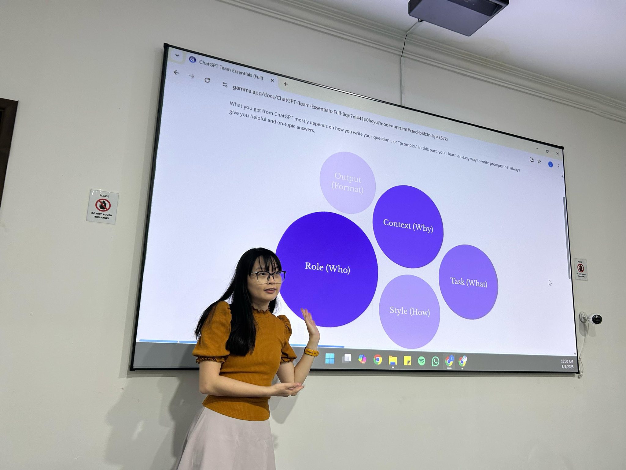 Trainer teaching AI prompting framework on large screen