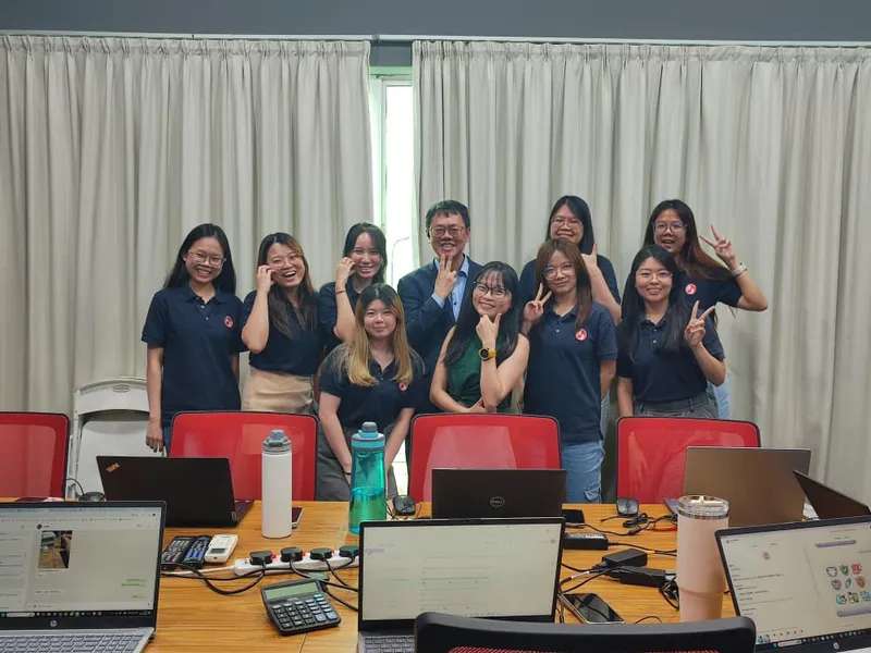 Corporate team in branded uniforms posing after AI training session