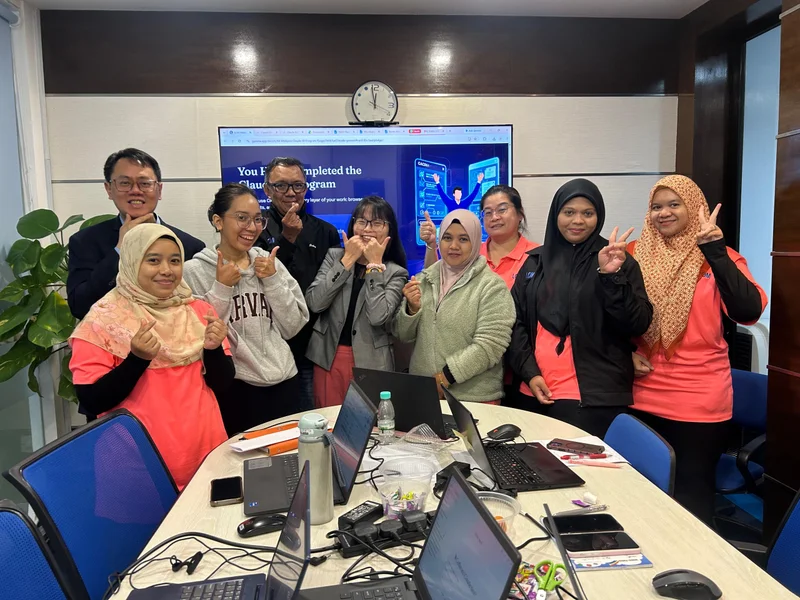 Corporate team celebrating completion of the Claude AI training program in their meeting room