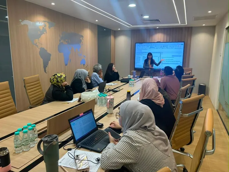 Trainer conducting AI training session with hands-on spreadsheet demonstration