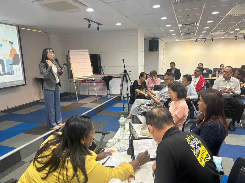Trainer walking participants through AI tool setup steps written on a flipchart