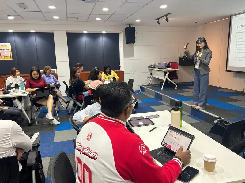 Trainer presenting a hands-on AI exercise to a full room of advisors
