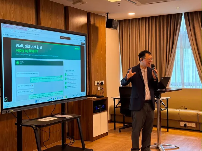 Speaker presenting AI-powered WhatsApp automation at a talk